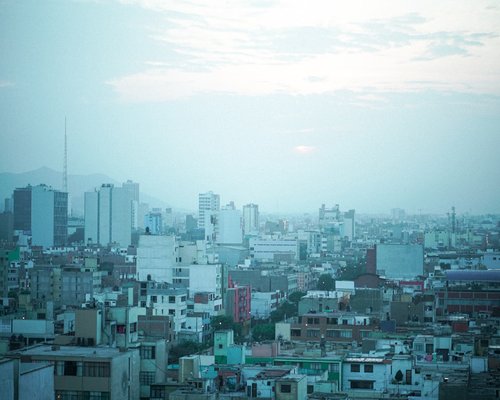 View of a cloudy sky in Lima from a cozy home office window