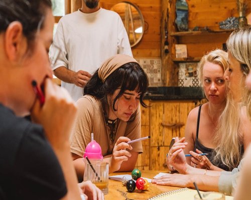 A small team of lifestyle educators collaborating around a table with notebooks